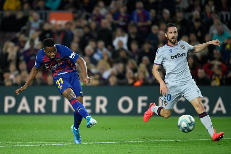 Barcelona\'s Guinea-Bissau forward Ansu Fati (L) scores during the Spanish League match between FC Barcelona and Levante UD at the Camp Nou Stadium in Barcelona