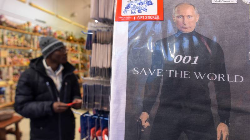 On magnets, mugs and matryoshka dolls, Putin's face still sells