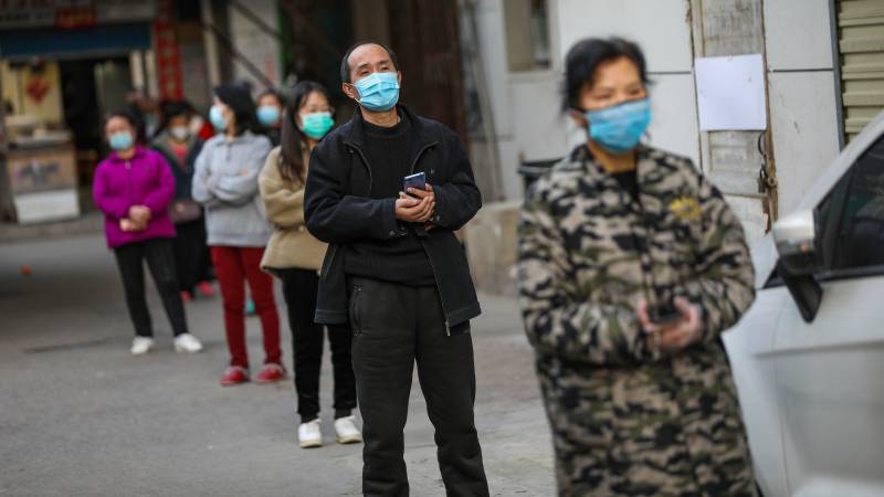 Wuhan waits for barriers to come down as virus storm subsides