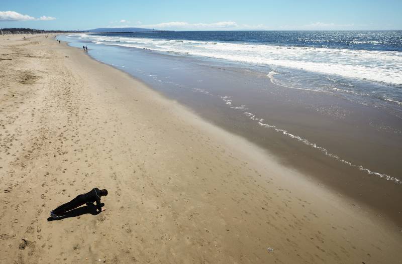 Packed California beaches prompt stricter virus measures