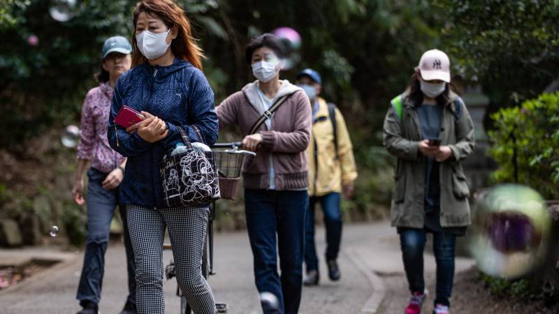 Japan virus cases surge over 10,000 with hospitals stretched