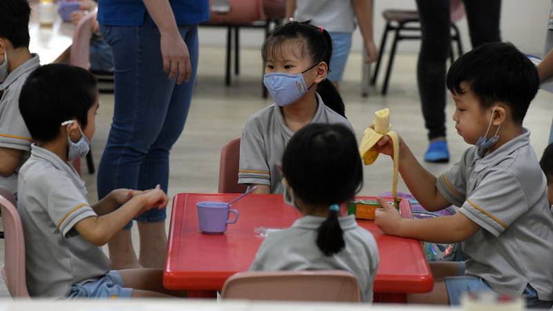 Back to school in masks as Singapore eases virus curbs