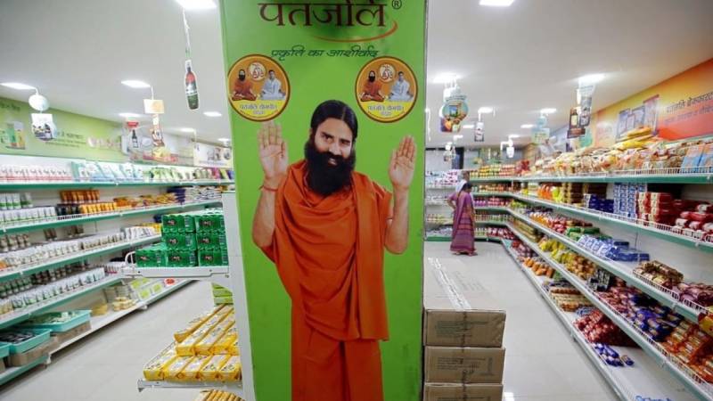 Indian guru warned against marketing $7 herbal virus 'cure'