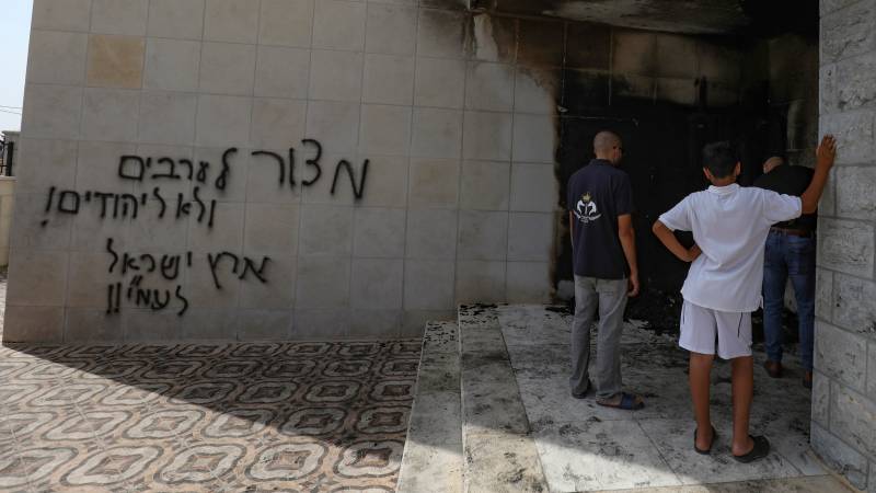 Fire, anti-Arab graffiti damage West Bank mosque