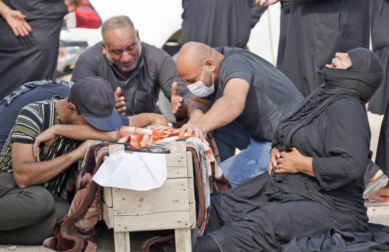 Iraqis dig up Covid-19 dead to rebury in family graves