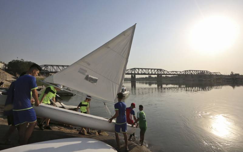 Sailing Baghdad's river bends, young Iraqis rock the boat