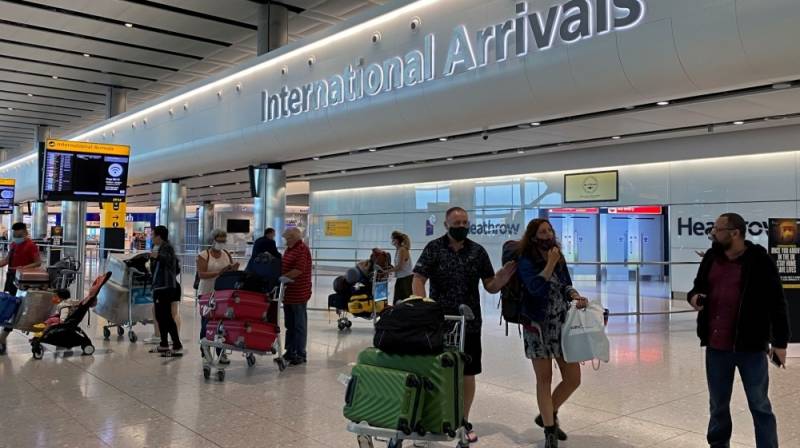 UK to reduce virus quarantine for travellers