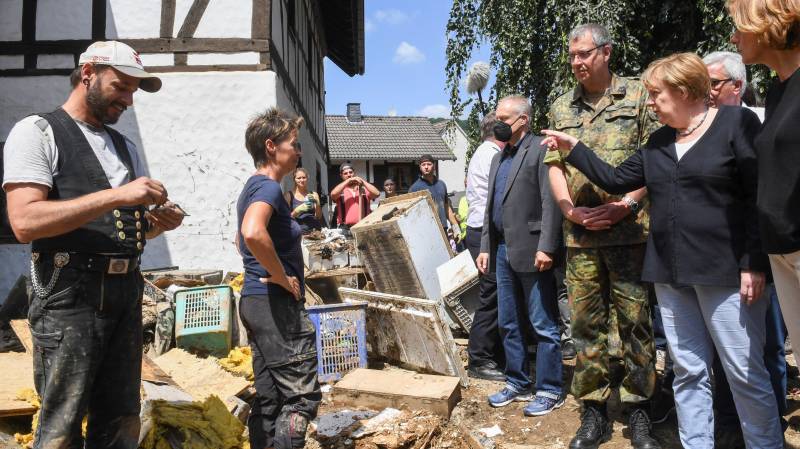 Merkel visits 'surreal' flood zone as death toll rises