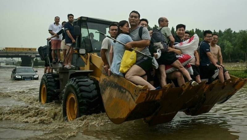 Villagers flee fresh floods in central China as typhoon approaches