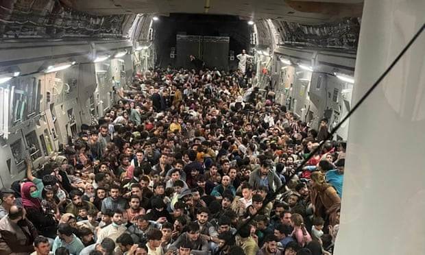 More than 600 fleeing Afghans cram into dramatic US military flight