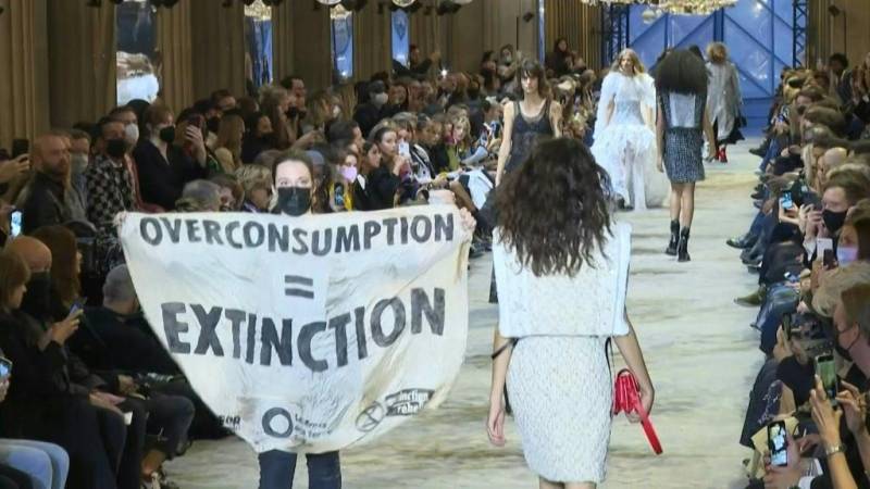 Climate demonstrators invade Paris catwalk show