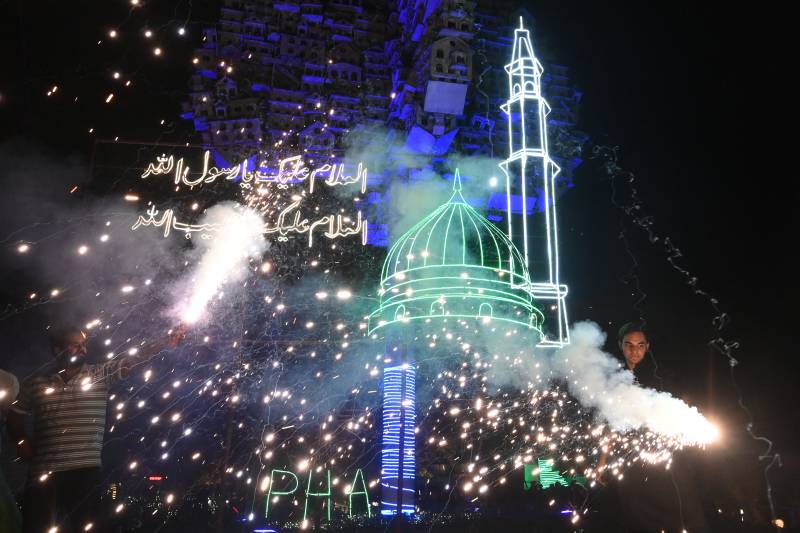 Youth play with fireworks during the celebrations for Eid-e-Milad-un-Nabi, in Lahore on October 18, 2021. AFP