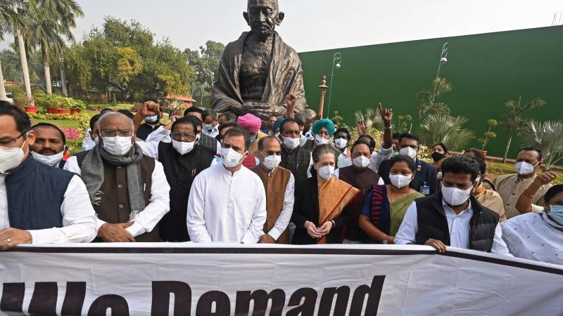 India's Congress party leaders Sonia Gandhi (4R) and her son Rahul Gandhi (5L) along with other party members take part in a protest against the central government's agricultural reform laws during the winter session of the parliament in New Delhi. AFP