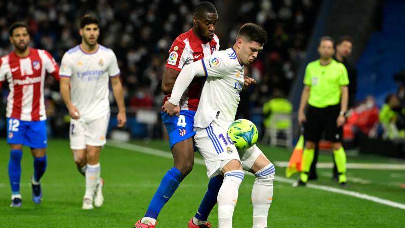 Real Madrid's Serbian forward Luka Jovic (R) vies with Atletico Madrid's French midfielder Geoffrey Kondogbia during the Spanish league match between Real Madrid CF and Club Atletico de Madrid. AFP