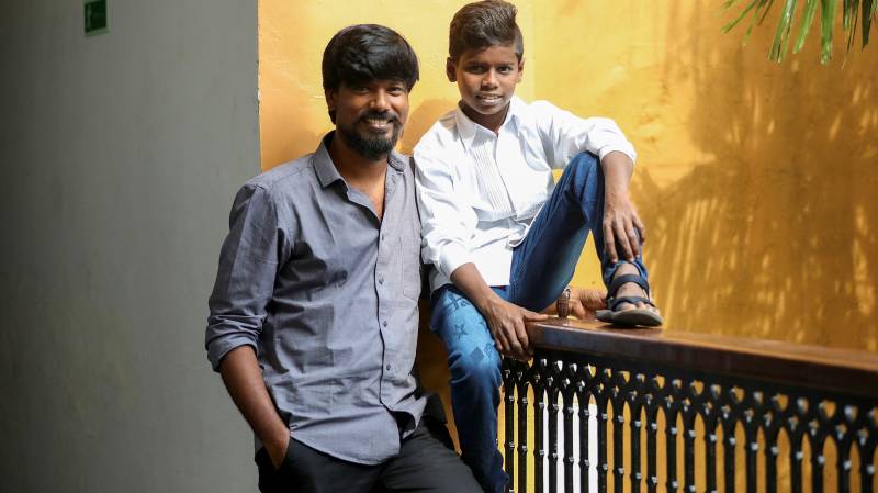 Tamil film director P.S. Vinothraj (L) poses with actor Chellappandi during the 52nd International Film Festival of India in Panaji. AFP