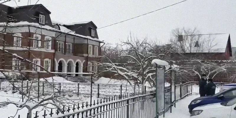 This handout image released by the Russian Investigative Committee shows law enforcement officers standing guard by the Orthodox gymnasium of the Vvedenskiy Vladychniy convent after an 18-year-old graduate of this educational institution entered the school and blew himself up. AFP