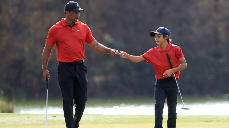 Tiger Woods and Charlie Woods celebrate a birdie on the 13th hole during the final round of the PNC Championship. AFP