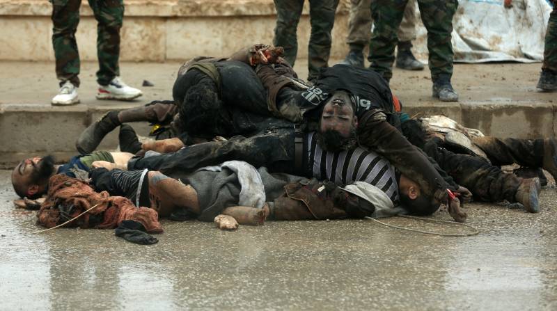 Bodies of alleged members of the Islamic State (IS) group killed in recent confrontations, are piled up in the neighbourhood of Ghwayran in the northeastern Syrian city of Hasakeh. AFP