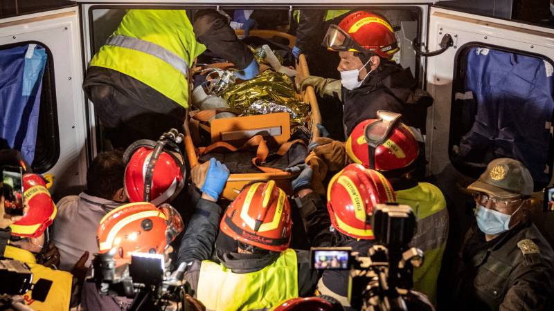 Moroccan emergency teams place the body of five-year-old Rayan Oram in an ambulance after pulling him from a well shaft he fell into on February 1. AFP