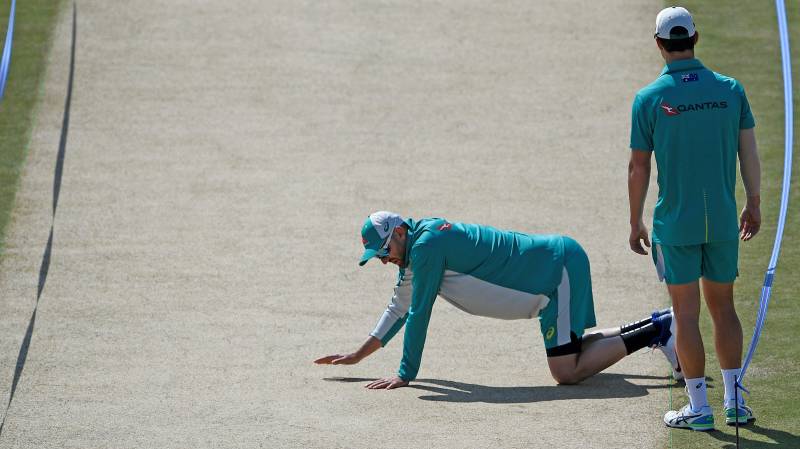 Australia's Nathan Lyon (L) inspects the pitch before a practice session at the Pindi Stadium in Rawalpindi on March 1, 2022, ahead of the first Test between Pakistan and Australia. AFP