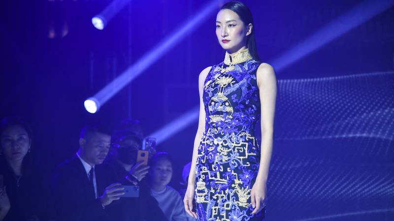 This photo shows a model wearing traditional Chinese dress Qipao rehearsing for a Shanghai fashion show. AFP