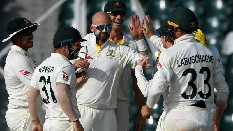 Australia's Nathan Lyon (C) celebrates with teammates after taking the wicket of Pakistan's Hasan Ali (during the fifth and last day of the third and final Test between Pakistan and Australia at the Gaddafi Stadium in Lahore. AFP