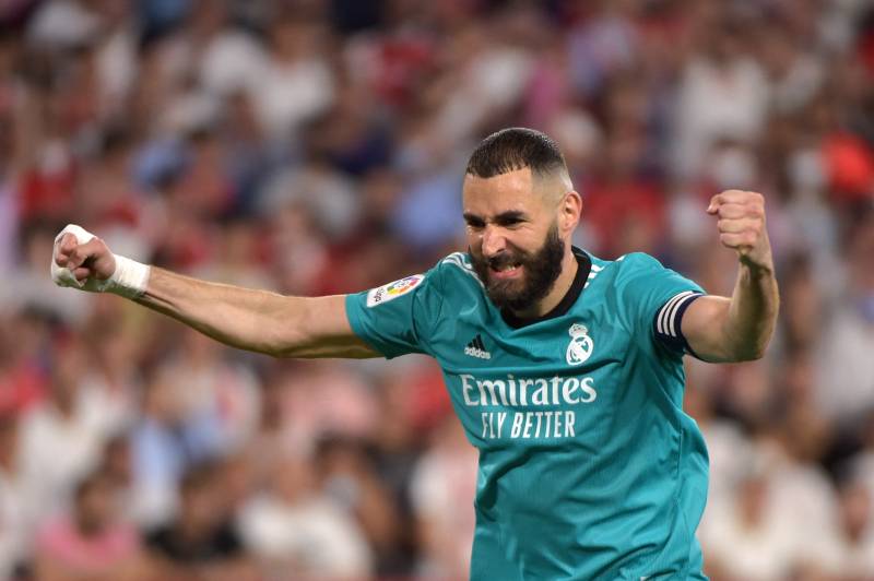 Real Madrid's French forward Karim Benzema celebrates after Real Madrid's Spanish defender Nacho Fernandez scored a goal during the Spanish League football match between Sevilla FC and Real Madrid CF at the Ramon Sanchez Pizjuan stadium. AFP