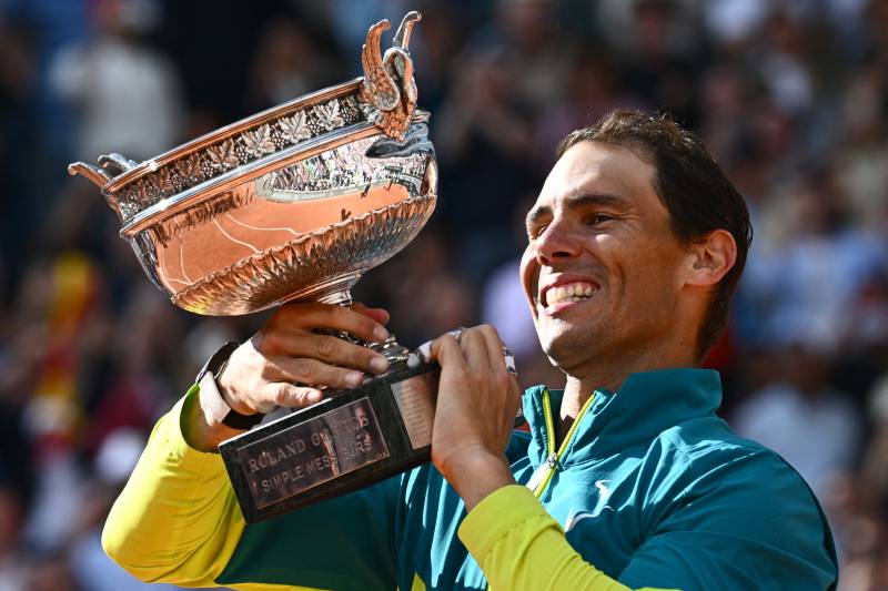 Spain's Rafael Nadal poses with The Musketeers' Cup as he celebrates after victory over Norway's Casper Ruud during their men's singles final match on day fifteen of the Roland-Garros Open tennis tournament at the Court Philippe-Chatrier