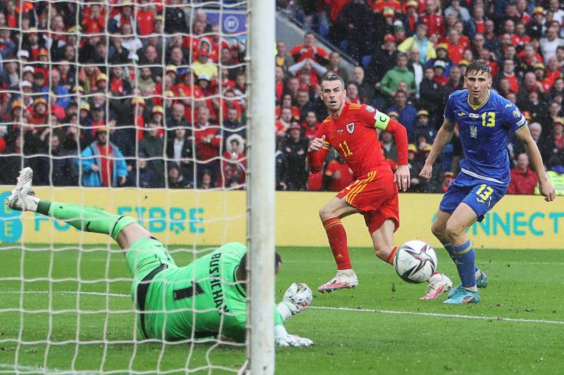 Wales' striker Gareth Bale (C) shoots to goal as Ukraine's goalkeeper Georgiy Bushchan (L) makes a save. AFP