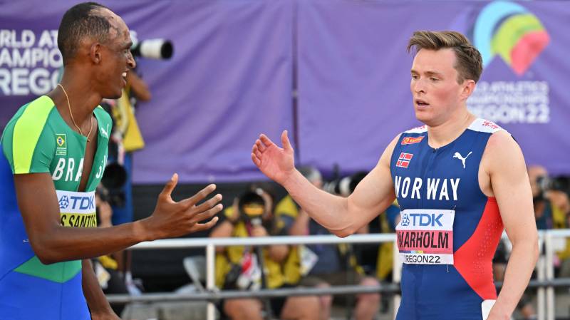 Gold medallist Brazil's Alison Dos Santos (L) shakes hands with Norway's Karsten Warholm after the men's 400m hurdles final during the World Athletics Championships at Hayward Field in Eugene, Oregon. AFP