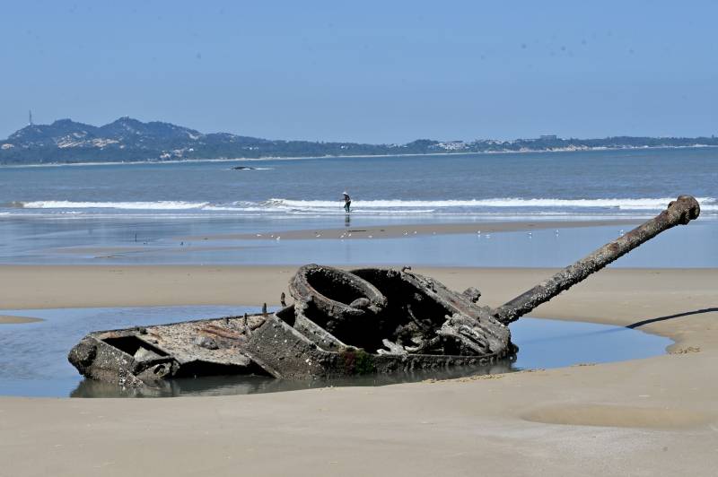 The rusted out wreckage of an old tank is seen at Ou Cuo Sandy Beach on Taiwan's Kinmen islands, which lie just 3.2kms (two miles) from the mainland China coast, on August 11, 2022. AFP