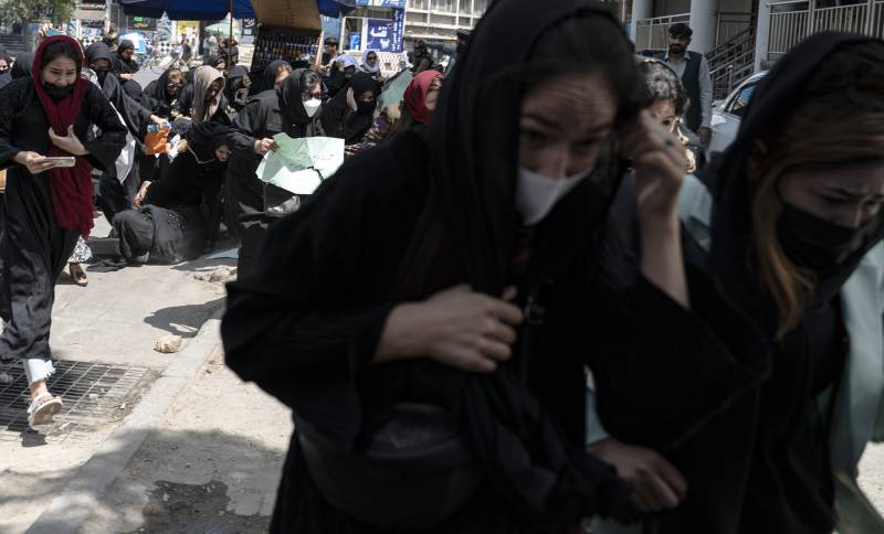 Taliban fighters fire into the air to disperse Afghan women protesters in Kabul.–AFP