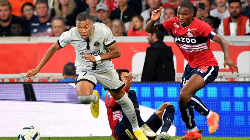 Paris Saint-Germain's French forward Kylian Mbappe (L) fights for the ball with Lille's French defender Bafode Diekite. AFP