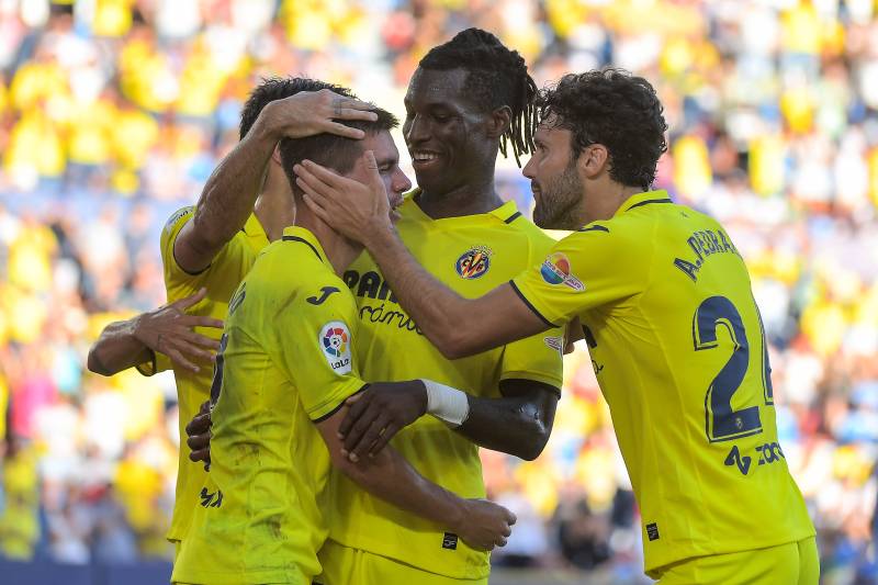 Villarreal's Argentinian midfielder Giovani Lo Celso (L) celebrates with teammates after scoring his team's second goal during the Spanish League match between Villarreal CF and Elche CF. AFP