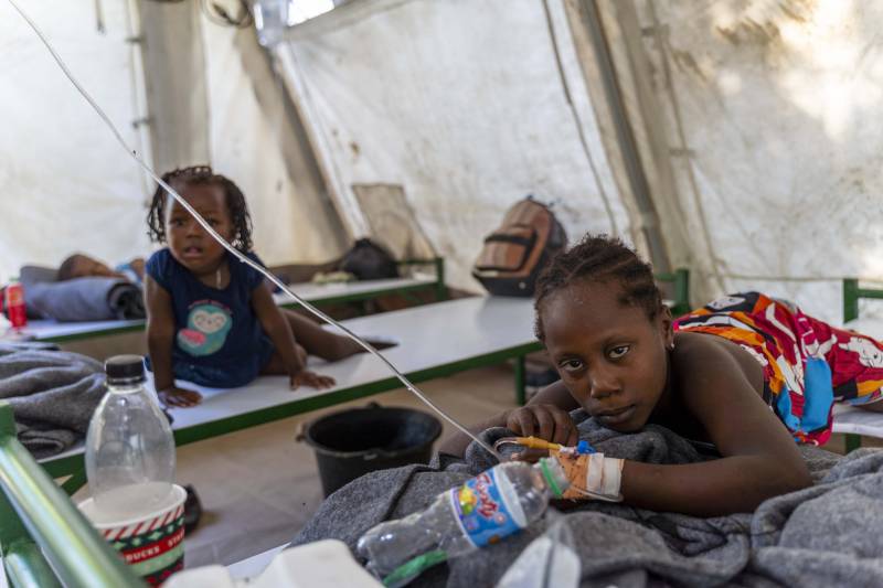 In this file photo taken on October 07, 2022, children showing symptoms of cholera receive treatment at a clinic run by Doctors Without Borders in Cité Soleil. AFP