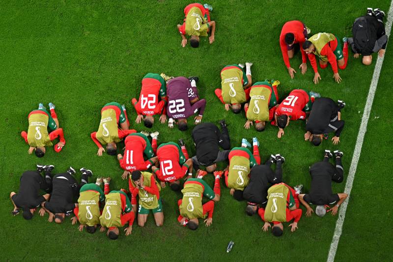 Morocco players offer Sajdah after winning the last 16 match against Spain. AFP