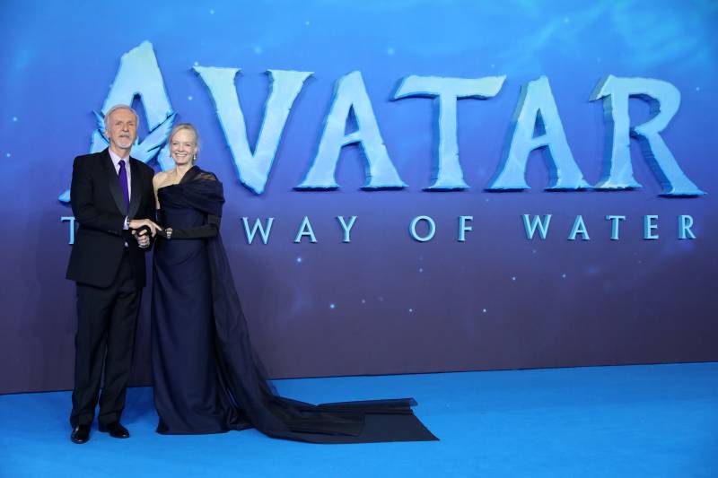 Canadian filmmaker James Cameron (L) and Suzy Amis Cameron (R) pose on the red carpet upon arrival for the World Premiere of the film 