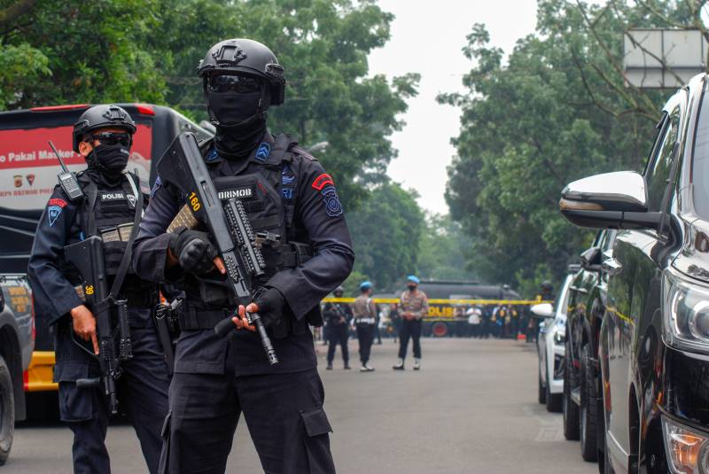 Police secure the site of a suicide bombing outside a police station at Astanaanyar in Bandung, West Java province. AFP