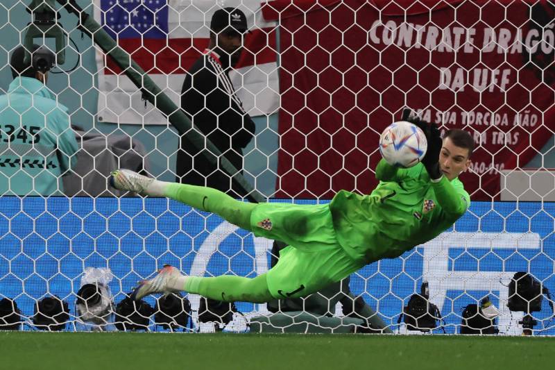 Croatia's goalkeeper Dominik Livakovic saves a shot by Brazil's forward Rodrygo during penalty shoot-out in the Qatar 2022 World Cup quarter-final football match between Croatia and Brazil. AFP