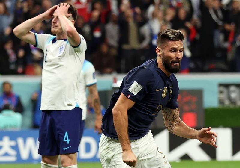 France's forward #09 Olivier Giroud celebrates scoring his team's second goal as England's midfielder #04 Declan Rice reacts during the Qatar 2022 World Cup quarter-final football match between England and France at the Al-Bayt Stadium in Al Khor, north of Doha, on December 10, 2022 - AFP