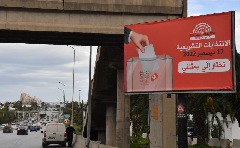 A billboard encouraging people to vote in the Tunisian national election scheduled for December 17 is displayed along the side of a road in Tunisia's capital Tunis. AFP