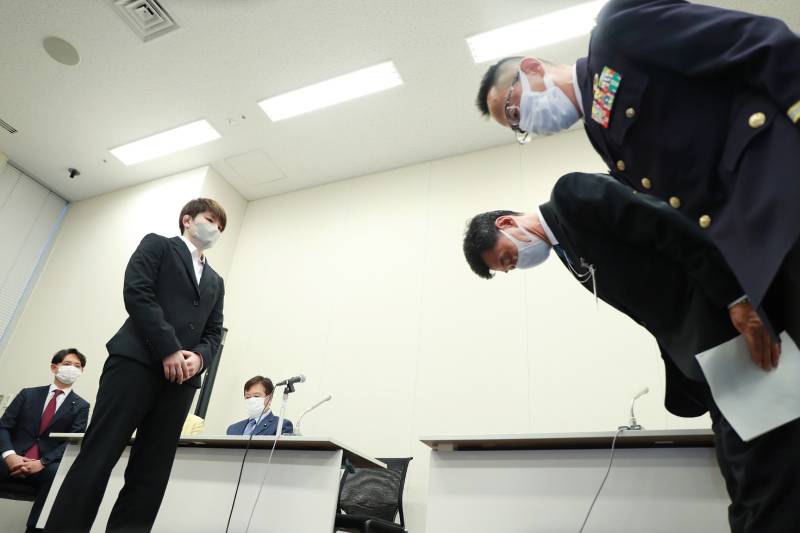 This file photo taken on September 29, 2022 shows members (R) of Japan's Ministry of Defense and Japan's Ground Self-Defense Force (JGSDF) bowing to apologise to former JGSDF soldier Rina Gonoi (L), who routinely faced sexual harassment and sexual assault at her unit and during training sessions, at a press conference at the House of Representatives Members' Office in Tokyo. AFP