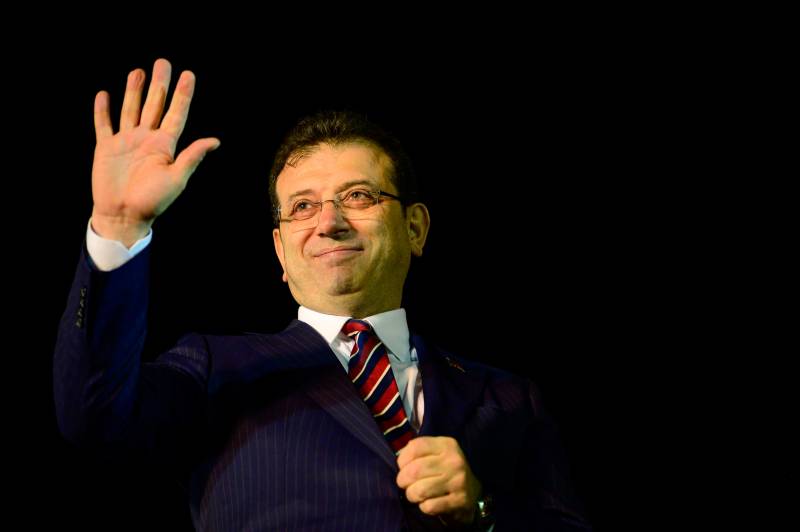 Istanbul Mayor Ekrem Imamoglu greets his supporters as they gather in front of Istanbul Metropolitan Municipality during a protest in Istanbul. AFP