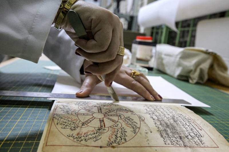 A conservator restores a manuscript at the Iraqi Manuscript House's restoration lab in Iraq's capital Baghdad. A curator in Baghdad pores over a 17th-century Persian manuscript, inside an annex of Iraq's national museum where she patiently undertakes delicate restoration work on the religious text. It is part of an enormous challenge Iraq has set itself -- preserving and digitising 47,000 of its ancient manuscripts and books. AFP 