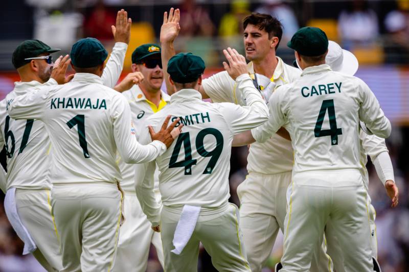 Australia's Pat Cummins (centre R) celebrates with teammates after taking the wicket of South Africa's Dean Elgar during day two of the first cricket Test match between Australia and South Africa at the Gabba in Brisbane on Sunday. AFP