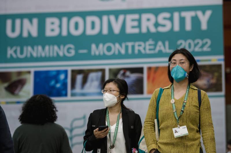 People walk in front of the convention sign at theUN Biodiversity Conference (COP15) in Montreal, Quebec, Canada, on December 17, 2022. AFP 