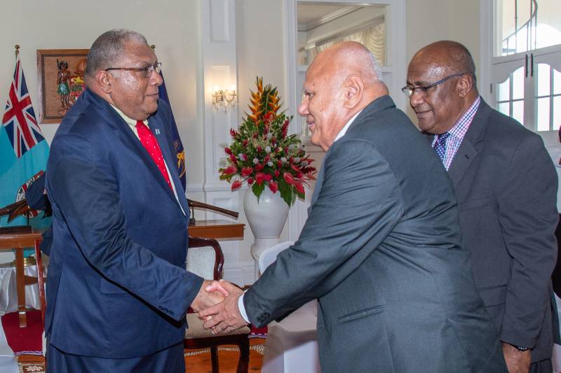 Fiji's President Ratu Wiliame Katonivere (L) shakes hands with the leader of the Social Democratic Liberal Party Viliame Gavoka (2R) during an oath taking ceremony of the newly elected government in the capital city Suva on December 24, 2022. Former military commander Sitiveni Rabuka was on December 24 confirmed as Fiji's prime minister, after accusing the outgoing government of stoking 