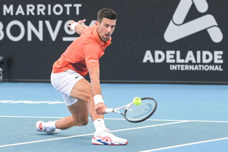 Serbian tennis player Novak Djokovic hits a return during his first round match against France's Constant Lestienne. AFP