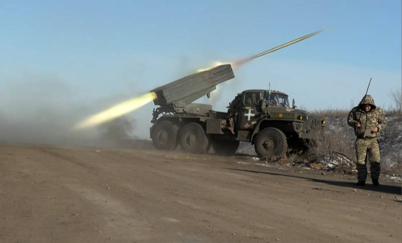 This grab taken from AFP video footage shows a member of Ukraine's military looking away as a BM-21'Grad' MLRS 122mm rocket launcher fires on the outskirts of Soledar. AFP