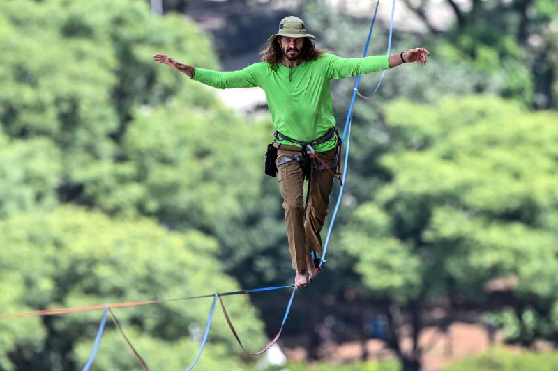 Brazilian highliner Rafael Bridi performs on a slackline 114 meters high and 510 meters long, crossing the entire Vale do Anhangabau, as part of the 469th anniversary of the city of Sao Paulo, Brazil . AFP